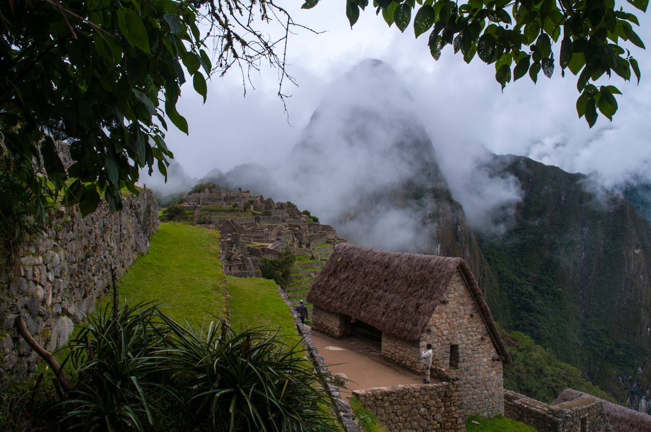 A cloudy day in Machu Picchu with the ancient ruins and stunning mountain backdrop. | Peruvian Sunrise