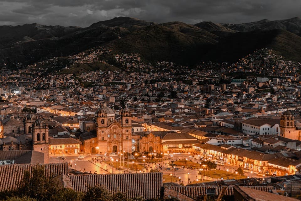 A vibrant street in Cusco featuring colonial architecture and Incan stone walls | Peruvian Sunrise