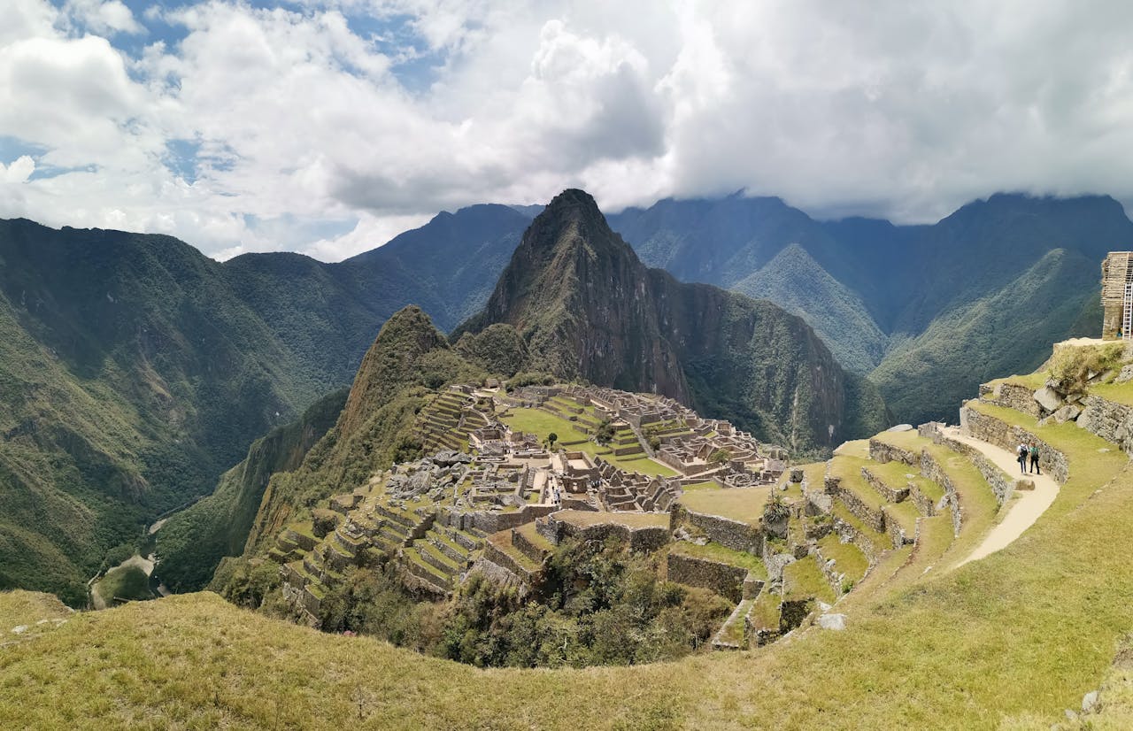 A sunny day in Machu Picchu, ancient ruins and stunning mountain backdrop. | Peruvian Sunrise