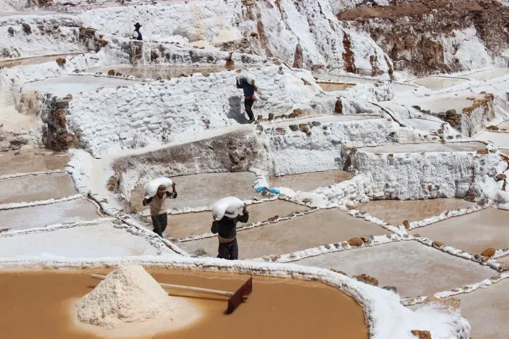 Aerial view of the Maras Salt Mines, with their unique terraced pools used for salt extraction | Peruvian Sunrise