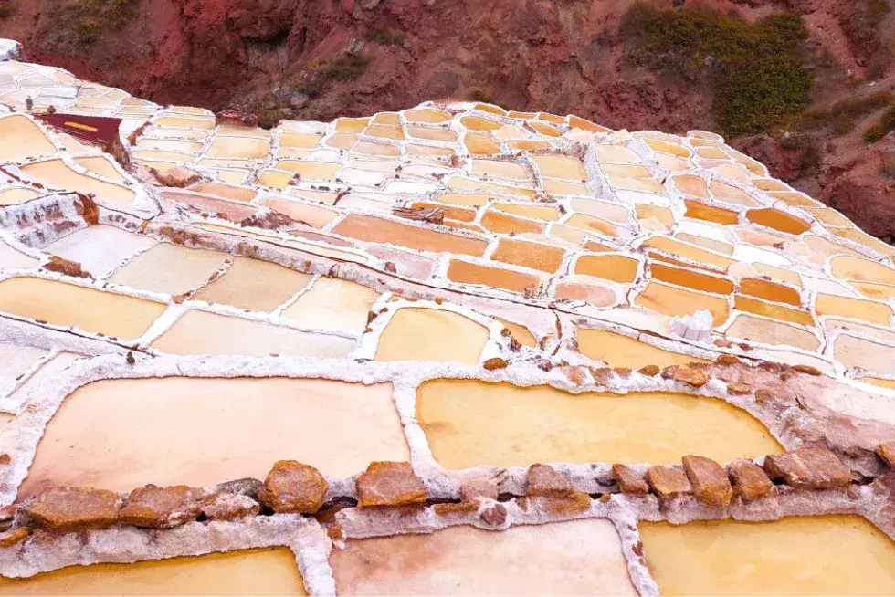 Witness the white salt pools of Maras, still harvested by hand in the Andes | Peruvian Sunrise